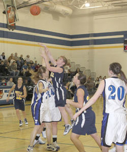 Oroville senior Kayla McKinney making a shot over Tonasket junior Jerian Ashley during Oroville’s away game at THS on Tuesday, Dec. 8. Also shown is Tonasket junior Shelby Olma (20). Photo by Terry Mills