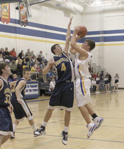 Tonasket junior Zach Neal shoots the ball over Oroville senior Brandon Funston during Tonasket’s home victory over Oroville on Tuesday, Dec. 8. Photo by Terry Mills