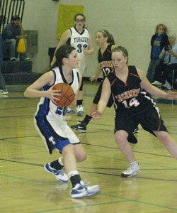 Tonasket junior Shelby Olma looks for a teammate to pass to past Cashmere senior Shelby Holt during Tonasket’s home game against Cashmere on Saturday, Jan. 9. Photo by Emily Hanson