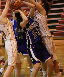 Shelby Olma, a junior for the Tonasket girls’ basketball team tries to make a shot against Cascade despite having the Kodiaks blocking it from either side during Tonasket’s loss to Cascade on Saturday, Jan. 16. Photo by Ian Dunn