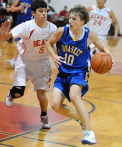 Tonasket sophomore John Stedtfeld moves the ball down the court to the hoop while keeping it away from a Brewster defender during Tonasket’s away game against the Bears on Friday, Jan. 22. Photo by John F. Cleveland, II