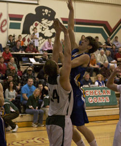 Tonasket junior Colton Ayers tries to make a shot over a Chelan Goat during the Tigers’ away game against Chelan on Saturday, Jan. 30. Photo by Les Bowen