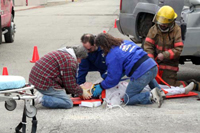 Students look on as EMS Coordinator Debra Donahue explains to them the dangers of drunk driving and how difficult it is to get someone out of a wrecked car.Oroville EMS Volunteers perform standard stabilizing procedures on the test dummy named Charlotte.S