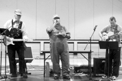 Superintendent Ernie Bartelson, Elementary Principal Joe Worsham and teacher John Ragsdale reward students with a selection of railroad songs.