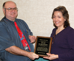 Oroville Elementary School Principal Joe Worsham presents Julie Schildgen with the Upper Okanogan 'Teacher of the Year' plaque from Wal-Mart Corporation. Submitted photo