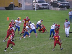 1457a Tonasket junior quarterback John Stedtfeld runs through Lake Roosevelt defenders during the Tigers’ first game of the season on Friday, Sept. 3. Also shown are seniors Lee Leavell (77, offensive lineman), Stephen Hulse (63, offensive lineman) and Corbin