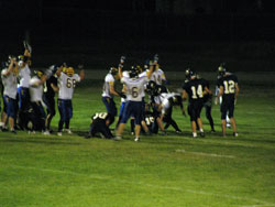 The Tonasket Tigers celebrate in Kettle Falls after junior quarterback John Stedtfeld scored the winning touchdown during overtime on Friday, Sept. 10. Photo by Emily Hanson