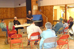 Tim King (standing) talks to local farmers and ranchers about adding canola as a cash crop to their current crop rotation. King plans on setting up a temporary, portable canola crusher in Oroville within the next two months and have a permanent crusher op