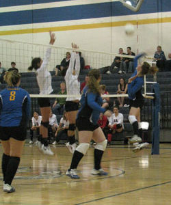 Tonasket senior Jessica Rhoads (right) slams the ball over the net against Omak while team mates senior Jayden Hawkins (middle) and junior Jessica Maier (left) prepare for the return hit during the Tigers’ home game against Omak on Saturday, Oct. 16. Ph