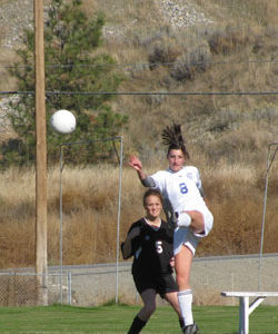 Tonasket junior Ashley Booker boots the ball away from an Omak opponent during Tonasket’s home game on Saturday, Oct. 16. Photo by Emily Hanson