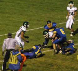 Tonasket senior linebacker Keegan McCormick wraps up Chelan junior wide receiver Cole Schwartz five yards from the goal line with help from fellow Tigers during Tonasket’s home game on Friday, Oct. 22. Photo by Emily Hanson