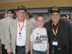 Henry “Hank” Allen from Oroville and his brother Loren, both veterans of World War II, with Justin Peterson at Spokane International Airport prior to the Allen’s flight to Washington, D.C. to see the World War II Memorial built in their and fellow W