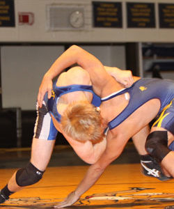 Tonasket’s Lee Leavell gets Oroville’s Nick Perez into a headlock as he works to throw him down to the mat during Tonasket’s match in Oroville on Wednesday, Dec. 8. Leavell won this match-up 5-4. Photo by Terry Mills