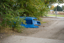 2130a A wrecked boat lies abandoned at the Chief Tonasket Park boat launch. Littering and illegal dumping have become a problem at the park, prompting city council discussion on how to remedy the situation. Photo by Brent Baker