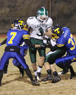 Tonasket's Jeff (7) and John (37) Stedtfeld gang up on a pair of Lakeside players during the Tigers' final game of the season on Friday, Nov. 4.