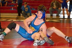 The Tigers' Austin Booker flashes a grin after completing a long-practiced move during a match at Saturday's Omak wrestling tournament.