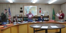 Newly reelected Oroville Council Members (standing, L-R) Ed Naillon, Walt Hart III and Neysa Roley are sworn in at the Tuesday, Dec. 19 council meeting. City Clerk-Treasurer Kathy Jones led the three council members in the oath while Councilmen Tony Koepk