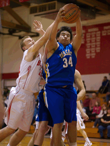 Photo by Brent Baker - The Tigers' Laz Ortega fends off Brewster's Easton Driessen during first round action at the Brewster Christmas Tournament on Thursday, Dec. 29.