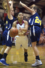 Photo by Brent Baker — Callie Barker (left) and Sierra Speiker try to contain Lake Roosevelt's Jada Desautel during Friday's loss to the Raiders.