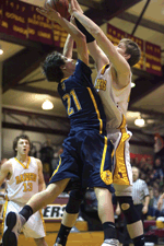 Photo by Brent Baker — Connor Hughes (21) and the Hornets had no answer for 6-8 Ty Egbert, who kept Oroville from scoring many points in the paint during Friday's contest.