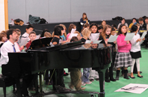 Students from Oroville Elementary School sing in honor of the Martin Luther King Jr. Holiday. They are accompanied on the piano by music teacher Jeff Gee. Photo by Gary DeVon