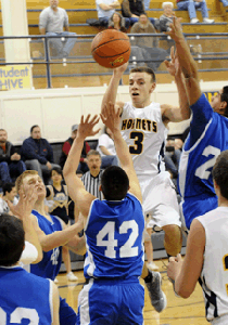 Oroville's CJ Mathews heads skyward for a two-point jumper against the Trojans. Mathews had 12 points against Manson. In the previous match up against the Trojans Mathews had a triple double.