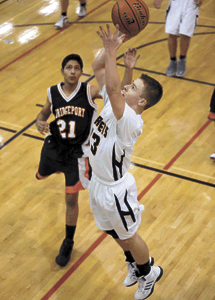 Photo by Brent Baker — Luke Kindred gets past Bridgeport's defense for two of his 10 points during Oroville's rout of the Mustangs last Tuesday.