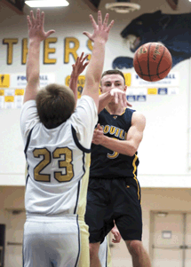 C.J. Mathews spots a teammate for an open layup during the Hornets' 66-52 upset of Riverside Christian on Monday, Feb. 13.