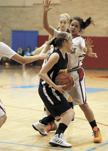 Photo by Brent BakerWhite Swan's physical defense gave Briana Moralez (1) and the Hornets fits early on, but Oroville adjusted to the Cougars' style of play and were only outscored by nine points in the final three quarters of Monday's loss.