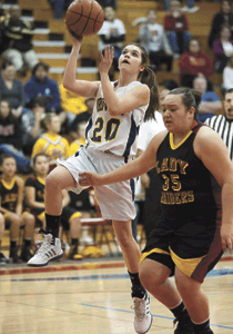 Photo by Brent Baker - The Hornets' Sierra Speiker cuts past Lake Roosevelt's Briana Monaghan on the way to the basket during Wednesday's season-ending loss to the Raiders.