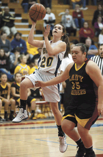 2384a Photo by Brent Baker - The Hornets' Sierra Speiker cuts past Lake Roosevelt's Briana Monaghan on the way to the basket during Wednesday's season-ending loss to the Raiders.