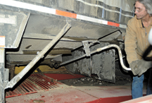 A truck driver from Lethbridge, Alberta opens the belly dump on the first of what's hoped to be many truckloads of canola seed from the prairies of Canada for Carbon Cycle Crush in Oroville. The company has set up operation to crush the seed for oil and m