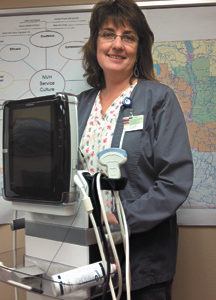 North Valley Hospital Director of Ancillary Services Noreen Olma shows of the hospital's new portable ultrasound unit at the NVH board of commissioners' meeting on Thursday, Feb. 23. photo by Brent Baker