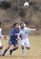 Tonasket's Oscar Avilez (16) fights for position as he looks for a header against Manson on Saturday, March 17.