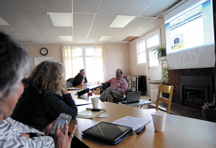 Clyde Andrews, president of the Oroville Chamber of Commerce, demonstrates the organization's new website at the chamber's general membership meeting held last Thursday, April 12 in the public library's conference room. Photo by Gary DeVon