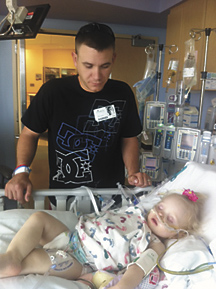 2534a Two days after donating one of his kidneys to his daughter, Hayden, Adam Brazil stands by her side.