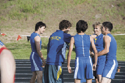 2574a Brent Baker / staff photo - Damon Halvorsen (second from left), who later would qualify for state in the 3200, celebrates with the 4x100 relay team of Zach Villalva, Smith Condon, John Stedtfeld and Jake Hickman after their own state qualifying run.
