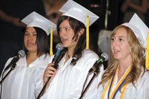 2626b Jasmine Grangroth, Cierra Williams and Co-Valedictorian Michelle Timmerman sing the National Anthem to open Saturday's graduation.