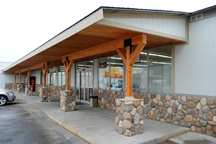 The owners of Frontier Foods have invested a lot in improving the exterior of their store, including new siding and paint, a reworked overhang out front, new river rock accents and a new sign (seen reflected in the window). A new roof is also being instal