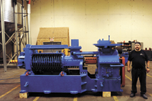 Leroy Smith, CCC Production Manager, stands next to a 1940/50's vintage French-brand seed crusher that was refurbished from two similar machines owned by the Carbon Cycle Crush. The machine, built in Piqua, Ohio, still needs to be hooked up to a 200HP ele