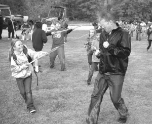 Tonasket Elementary  School Principal Jeremy Clark takes one for the "team" during the water fight/groundbreaking celebration for the Tonasket Water Park at Chief Tonasket Park on Friday.