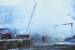 It took less than an hour for the small log machine and its building to be destroyed. The fire department was still soaking the area using their 50-foot ladder truck. Gary DeVon/staff photo
