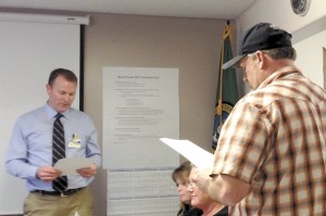 Oroville School District Superintendent Steve Quick administers the Oath of Office to Brad Scott as Oroville's newest school board member. Scott, who will serve at-large, actually lives in the pre-redistricting district that the board was having so much trouble in filling the director's position. Photo by Gary DeVon