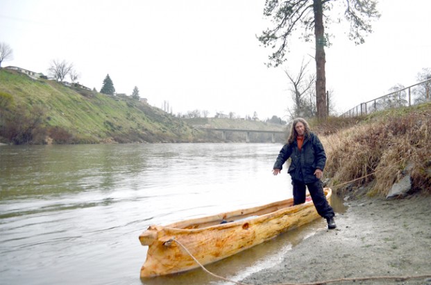 Clark pulls ashore in Omak Tuesday morning, March 24. Below, a metal eyebolt found embedded in the tree made a natural bowline anchor. The wolf's head is a tribute to George Lagergren, the Chinook elder who carved a canoe for the bicentennial reenactment of the Lewis and Clark Corps of Discovery's journey to the Pacific. It was the first dugout Churchill Clark laid eyes on, and he's been hooked ever since. 