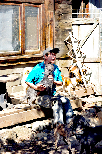 Carol Richards and some of the many dogs she has at her N.O. Paws Left Behind animal rescue. The N.O. in N.O. Paws stands for North Okanogan although the animal rescue from all over Okanogan County and adopts them to people living in the United States and Canada. Gary DeVon/staff photos