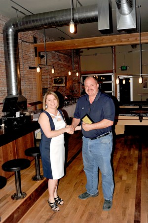 Jack Hughes was named “Citizen of the Year,” he was presented a plaque by Leah Palmer, chamber vice president.
