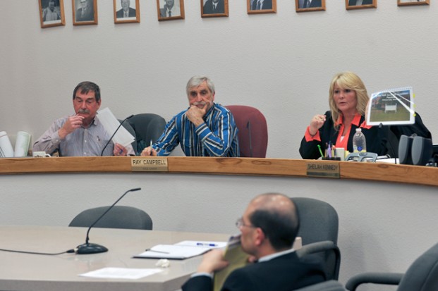 Okanogan County Commissioners Jim Detrol, Ray Campbell and Sheilah Kennedy, with Chief Civil Deputy Prosecutor Albert Lin. Kennedy is holding up a report on the county's current Juvenile Detention Facility. Gary De Von/staff  photo
