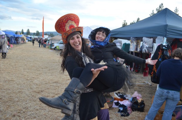 Hayden, Idaho's Rita Joy, the Mayor of Orange Street, lifts up Orange Street Vendor Sarah Edwards.