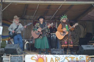 Steve Pollard, Sandy Vaughn, Deb Vestor and Miguel, all from Chesaw, entertain from the Solar Stage on Friday. They braved the falling snows  to perform again the next morning.