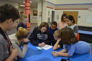 Above, Katie Abrahamson tallies up pounds of food collected per grade level while Tonasket Elementary ASB members anticipate the results. The fifth graders, who have been the reigning champions for pounds of food collected each year since the were in the third grade, prevailed once again, bringing in a total of 727 pounds of food during the week. Third graders placed second at 325.4 pounds of the 2,219.6 pounds collected school-wide. Pictured clockwise from left foreground are Tyge Plank, Isabel Steinshouer, Riley Corum, Katie Abrahamson, Tanner Tompkins, Emma Attwood, Maggie Ramon, Luke Martin and Emma Kerns.